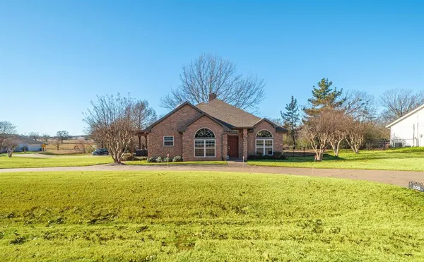 a big house with a big yard and large trees