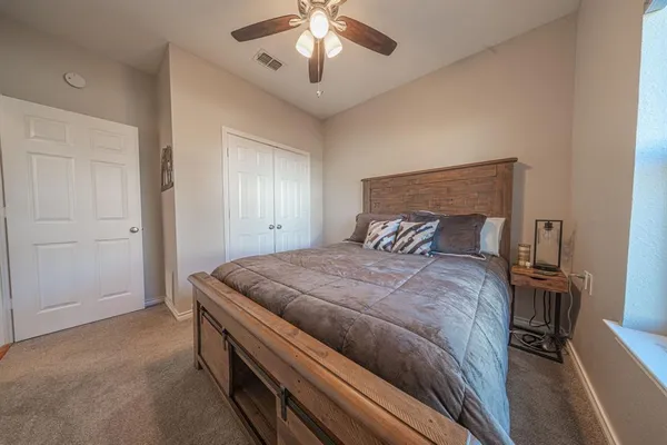 a bedroom with a bed and a chandelier