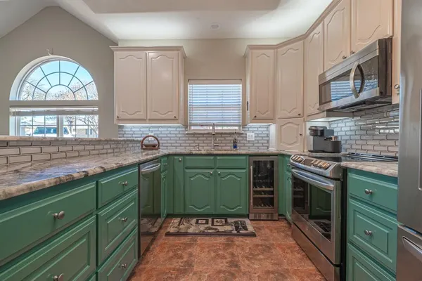 a kitchen with cabinets a window and a sink
