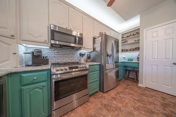 a kitchen with a stove and a refrigerator