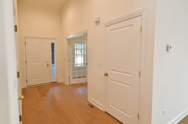 an empty room with windows and closet