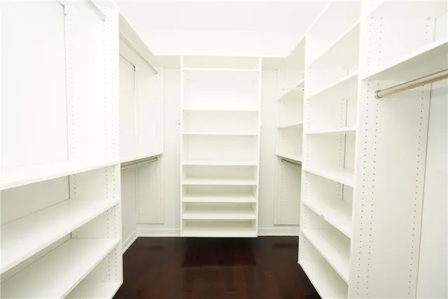 a view of walk in closet with empty racks