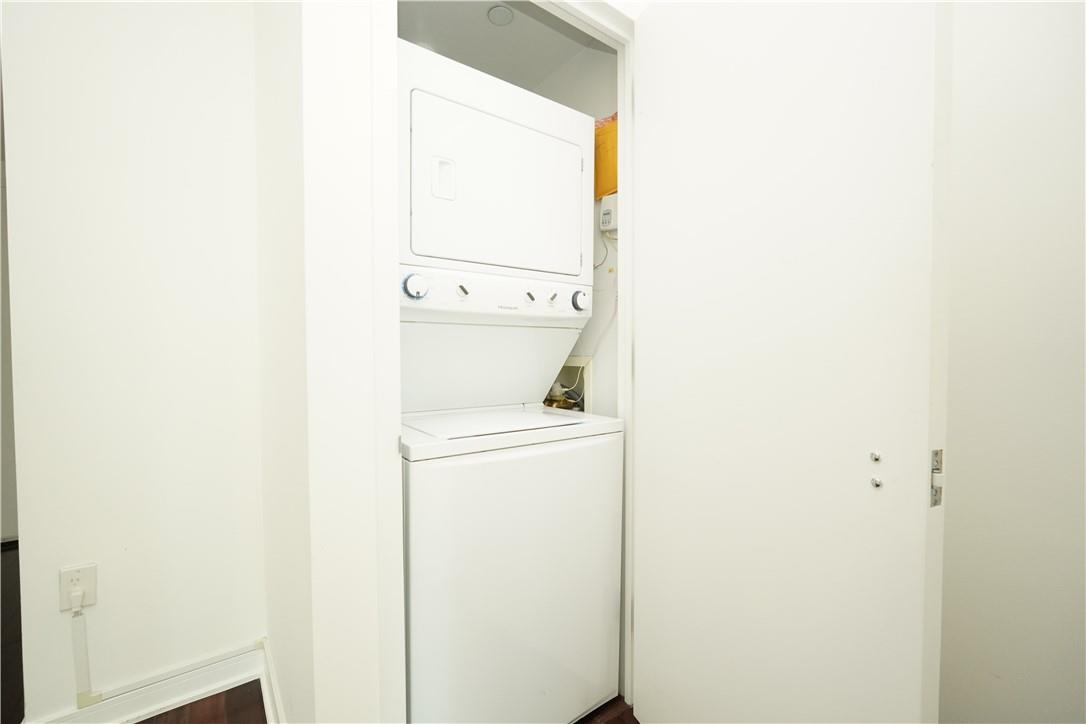 207 East 57th Street, Unit 21B Manhattan, NY 10022 - Photo 12 of 12 a utility room with dryer and washer