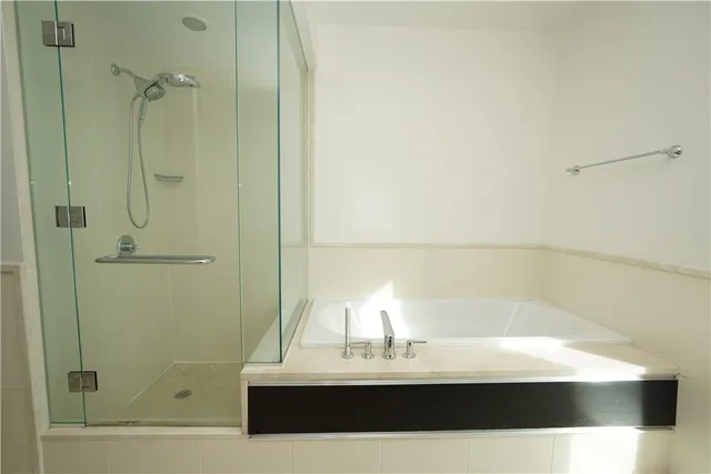 a bathroom with a bathtub and a shower