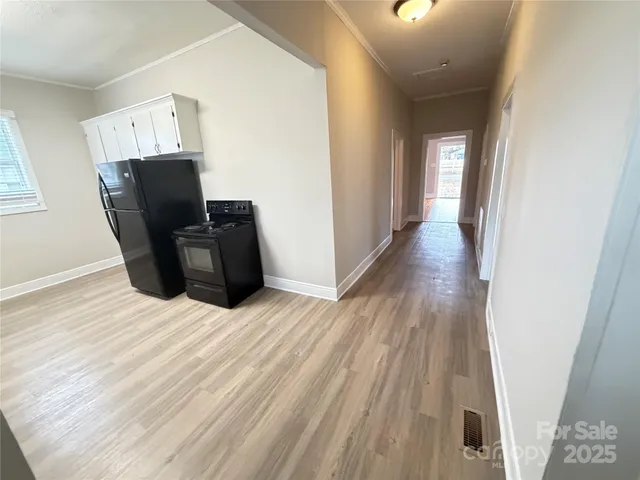 a room with wooden floor and windows