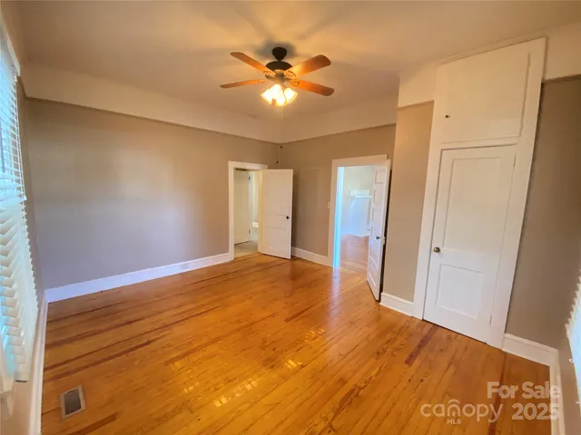 a view of an empty room with a ceiling fan