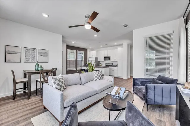 a living room with furniture or couch and a wooden floor