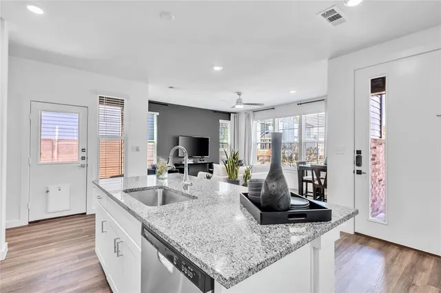 a kitchen with sink stove and refrigerator