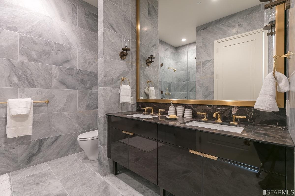 288 Pacific Avenue, Unit 2H San Francisco, CA 94111 - Photo 14 of 34 a bathroom with a double vanity sink toilet and a mirror