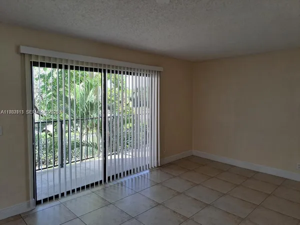 a view of an empty room and glass door