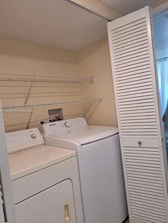 a utility room with dryer and washer