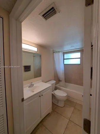 a bathroom with a double vanity sink toilet and shower