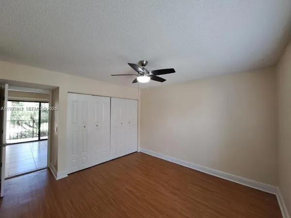 a view of empty room with wooden floor