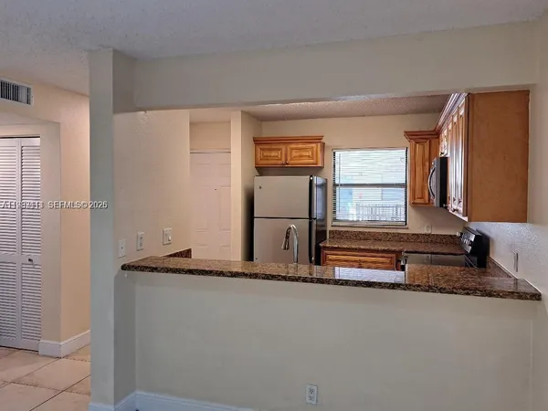 a living room with a bed and a large window