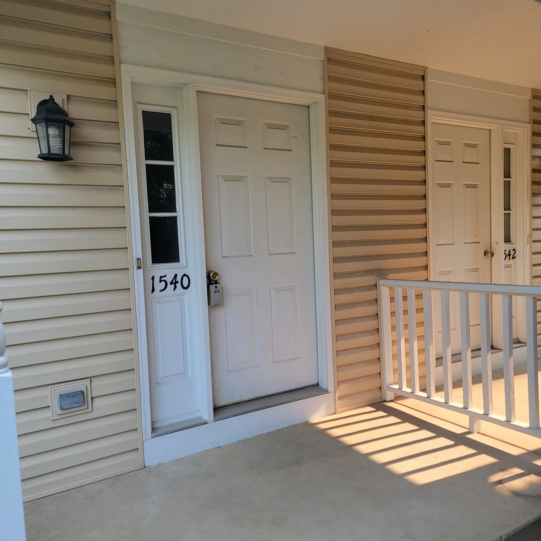 1540 Hickory Road, Unit 1540 Woodstock, IL 60098 - Photo 2 of 14 a view of a house with a door and a window