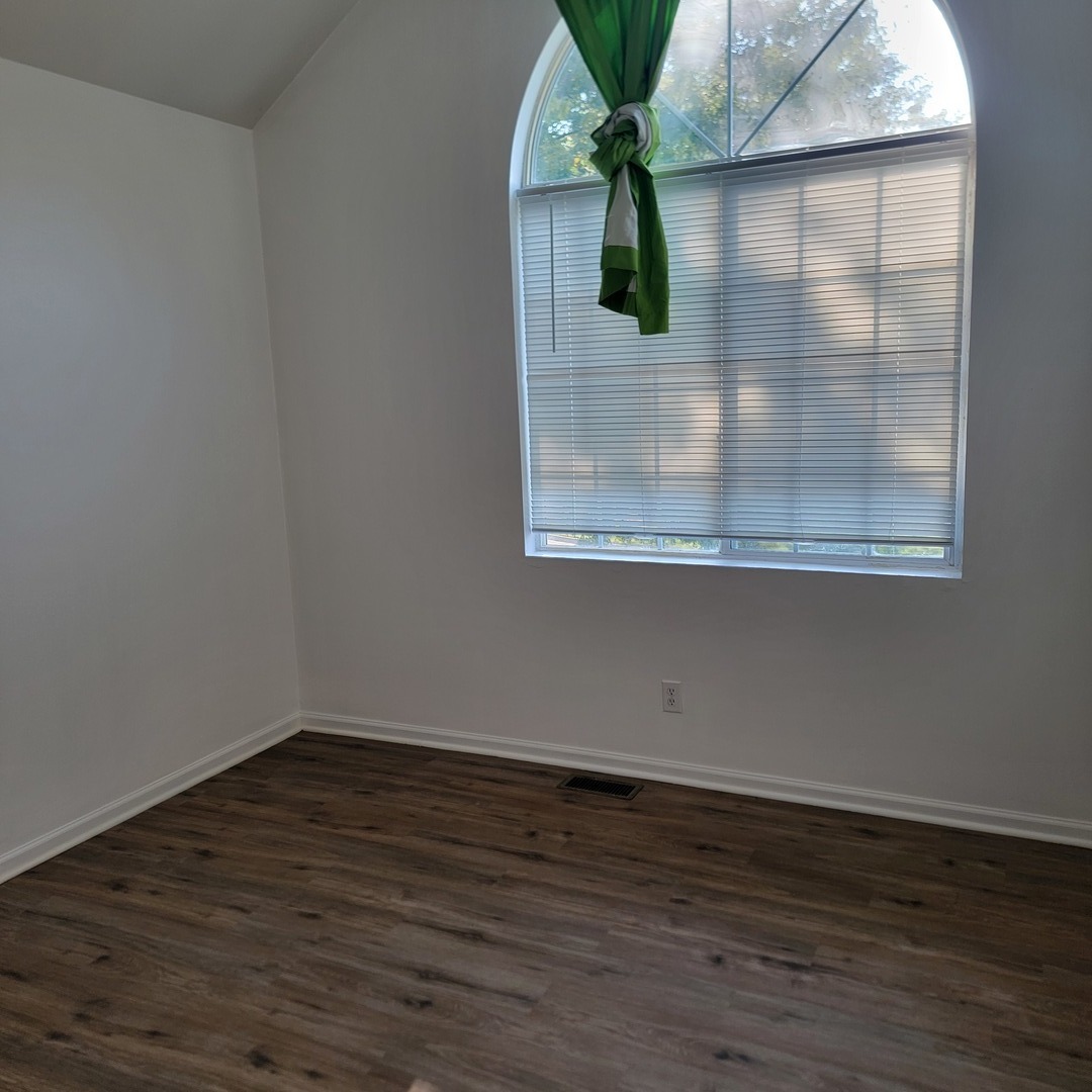 1540 Hickory Road, Unit 1540 Woodstock, IL 60098 - Photo 10 of 14 a view of empty room with wooden floor and fan