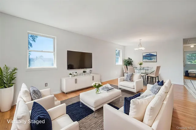 a living room with furniture a rug and a flat screen tv