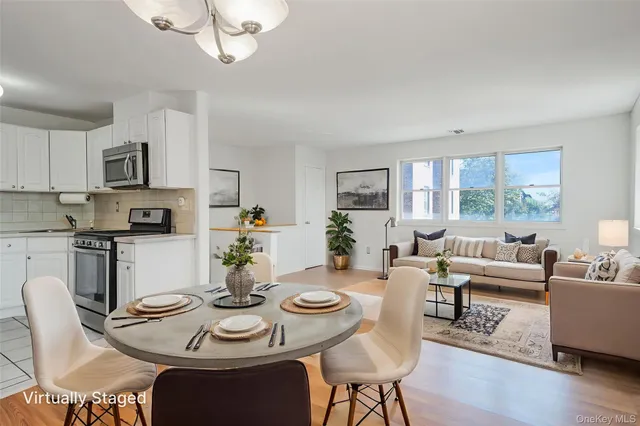 a view of a dining room with furniture a livingroom and wooden floor