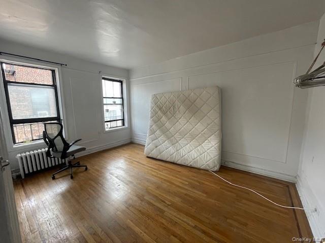 144-31 78th Road, Unit 3L Queens, NY 11367 - Photo 3 of 10 an empty room with wooden floor and windows