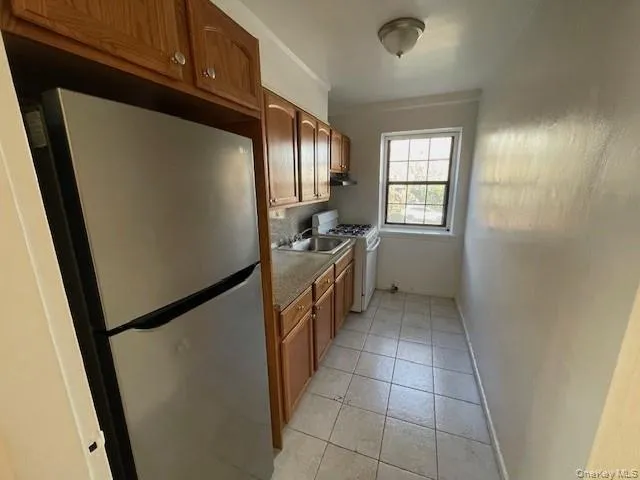 a kitchen with a refrigerator and a sink