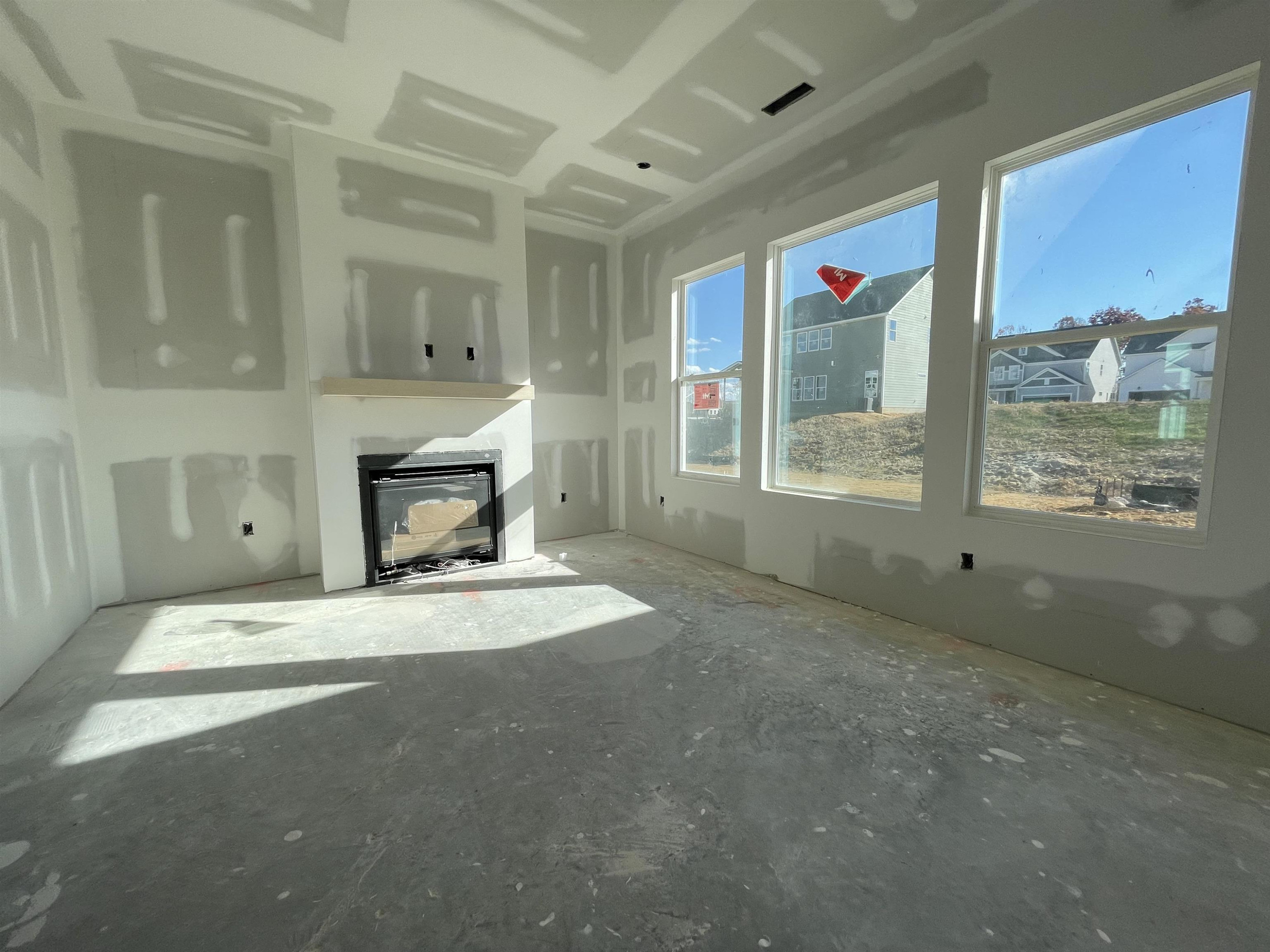 540 Marthas View Way Wake Forest, NC 27587 - Photo 11 of 25 a room with a fireplace and a window