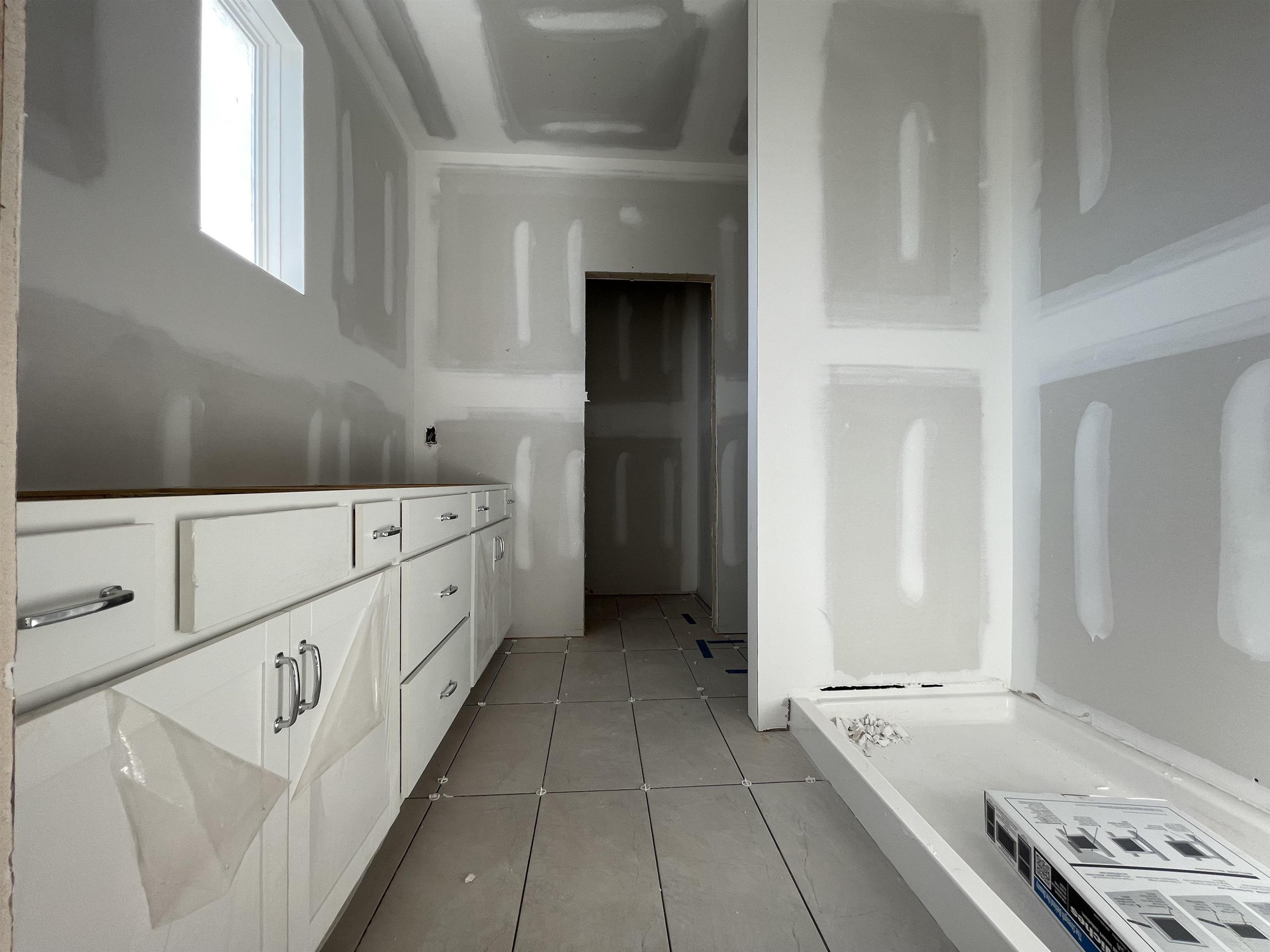 540 Marthas View Way Wake Forest, NC 27587 - Photo 19 of 25 a kitchen with white cabinets and white appliances