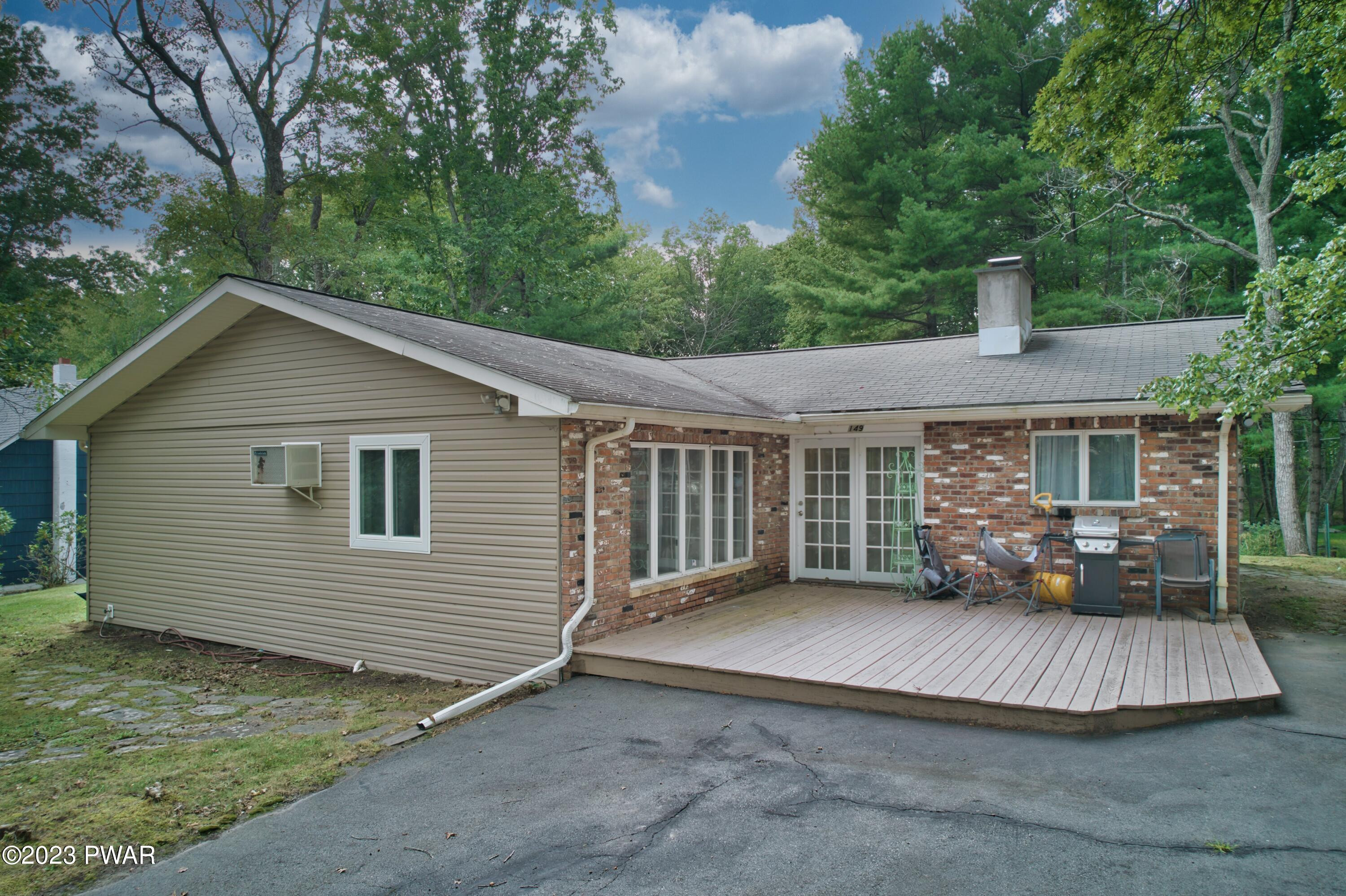 149 Walker Lake Road Shohola, PA 18458 - Photo 48 of 51 a view of a house with backyard and sitting area