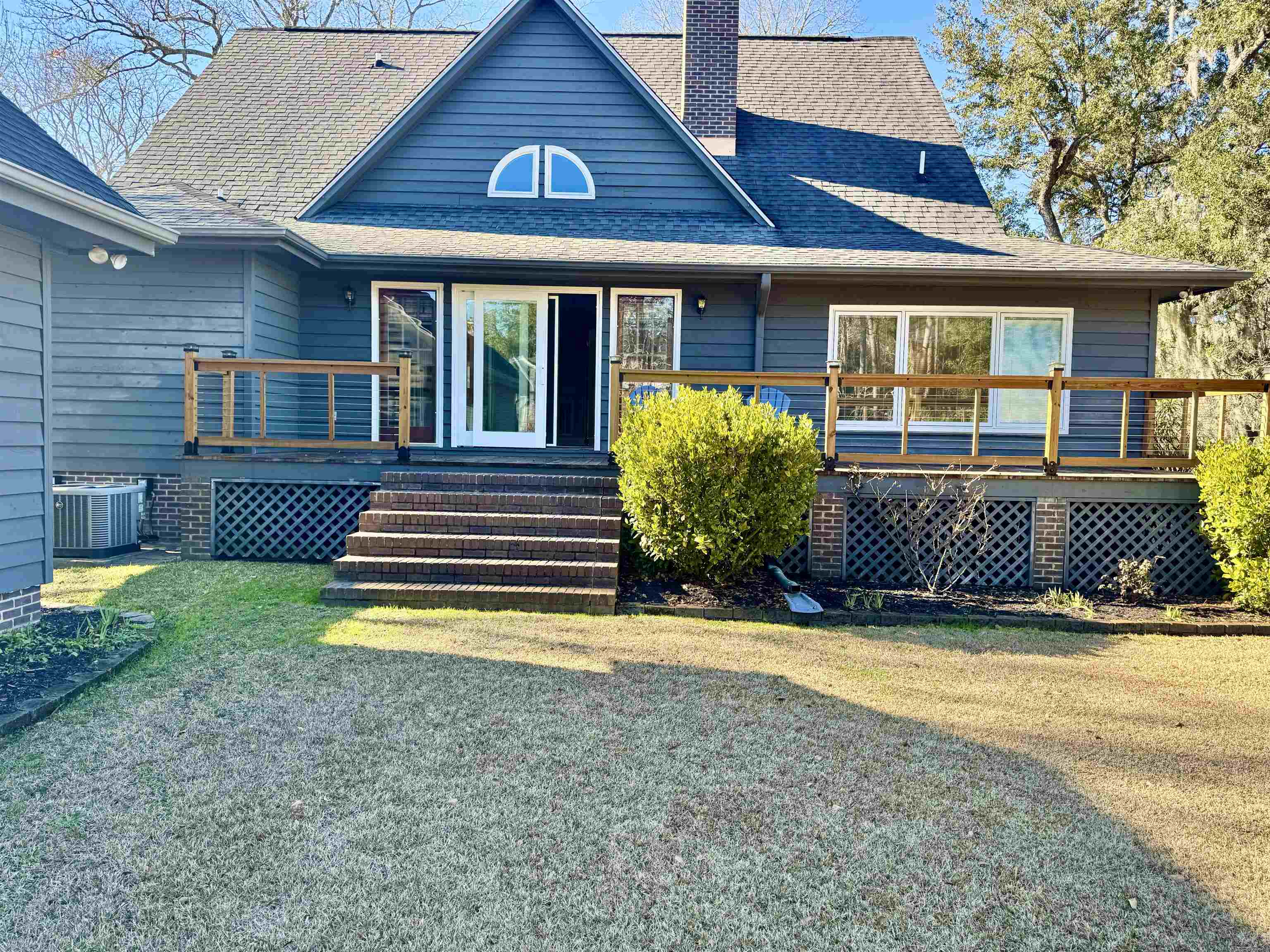 94 John Green Lane Georgetown, SC 29440 - Photo 24 of 35 Back of house with a deck, a lawn, a chimney, and roof with shingles