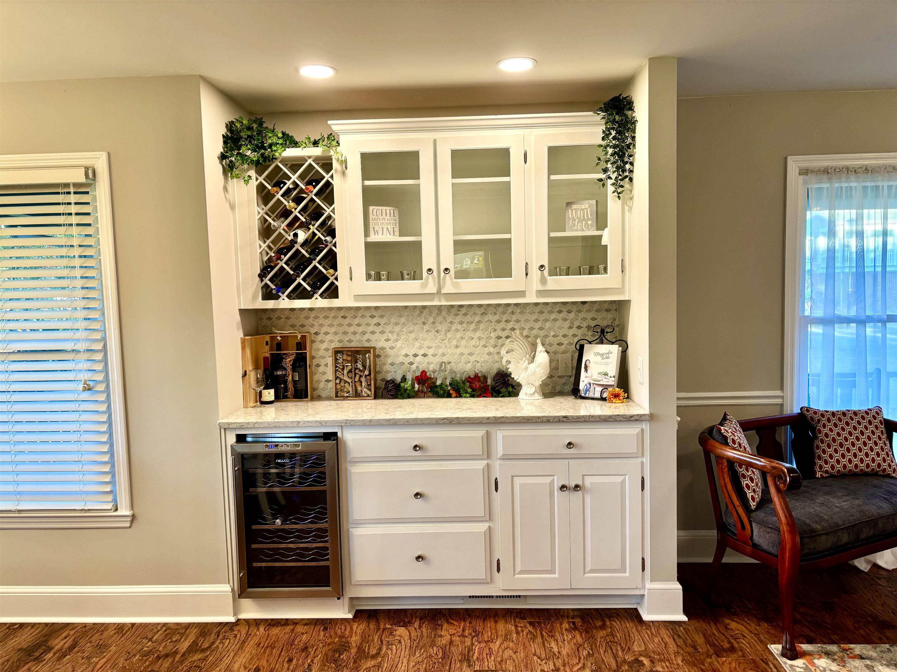 94 John Green Lane Georgetown, SC 29440 - Photo 4 of 35 Indoor dry bar featuring light stone counters, white cabinets, glass insert cabinets, wine cooler, and recessed lighting