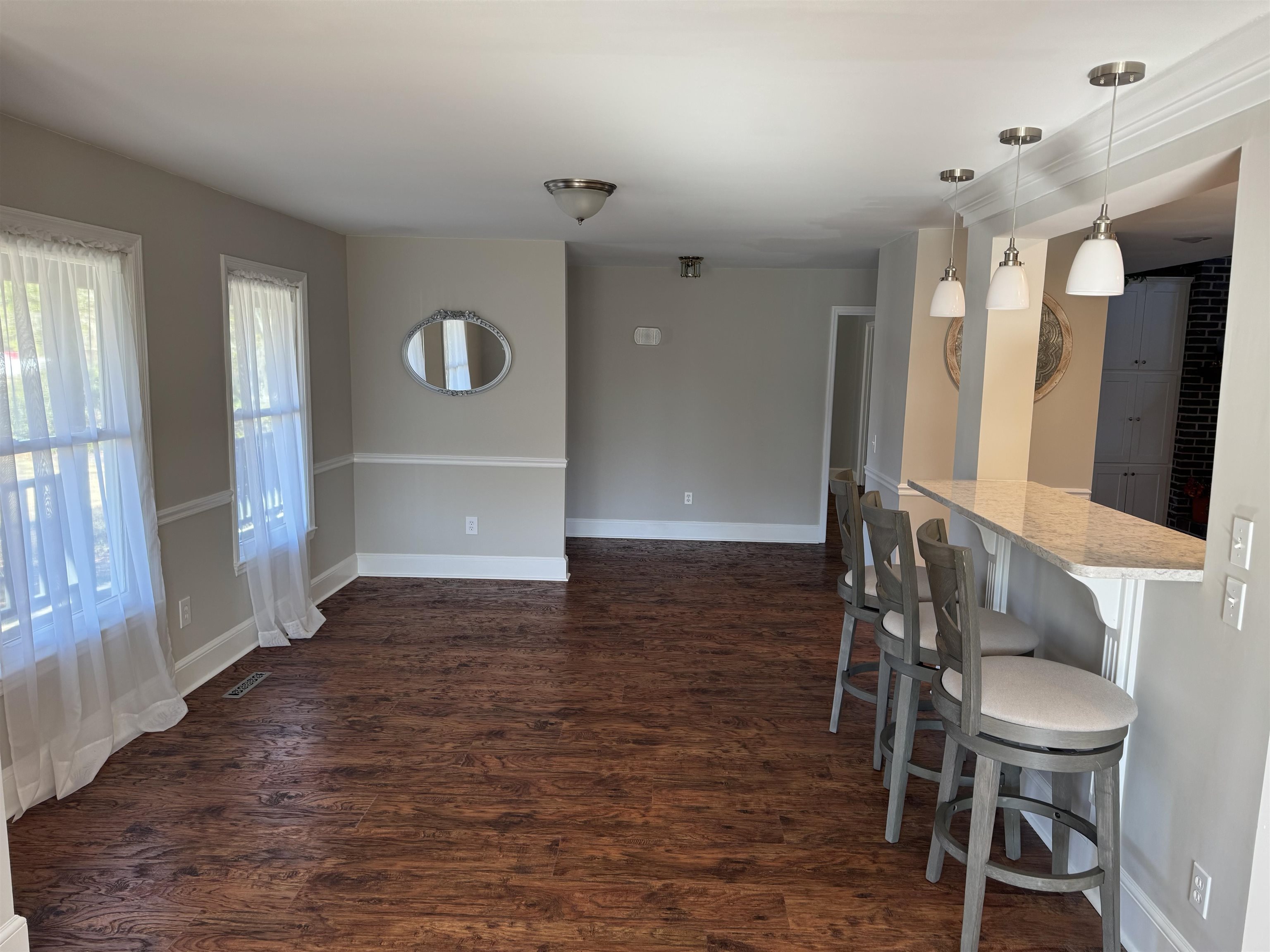 94 John Green Lane Georgetown, SC 29440 - Photo 9 of 35 Unfurnished dining area featuring dark wood-style floors and baseboards