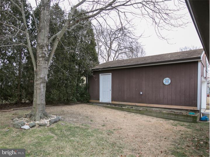 5 Evergreen Road Stratford, NJ 08084 - Photo 16 of 18 a front view of a house with a yard