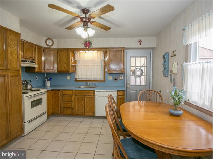 5 Evergreen Road Stratford, NJ 08084 - Photo 6 of 18 a kitchen with a table chairs sink and cabinets
