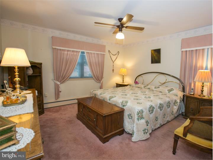 5 Evergreen Road Stratford, NJ 08084 - Photo 9 of 18 a bedroom with a bed and a chandelier