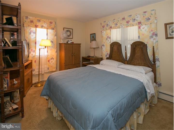 5 Evergreen Road Stratford, NJ 08084 - Photo 10 of 18 a bed sitting in a bedroom next to a window