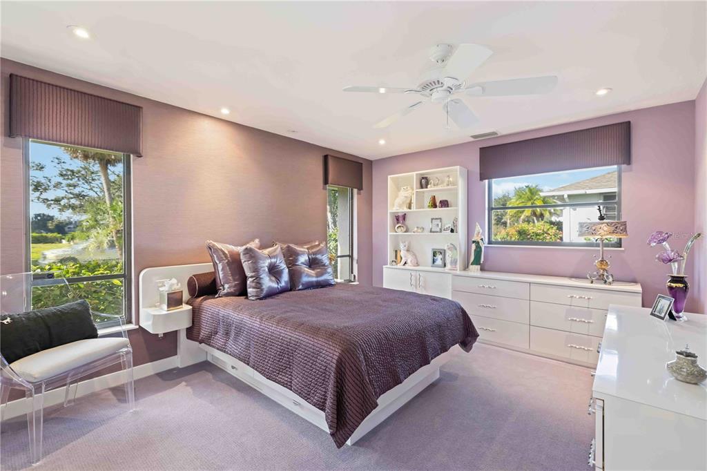 505 Lyons Bay Road Nokomis, FL 34275 - Photo 17 of 57 a bedroom with a large bed and a chandelier