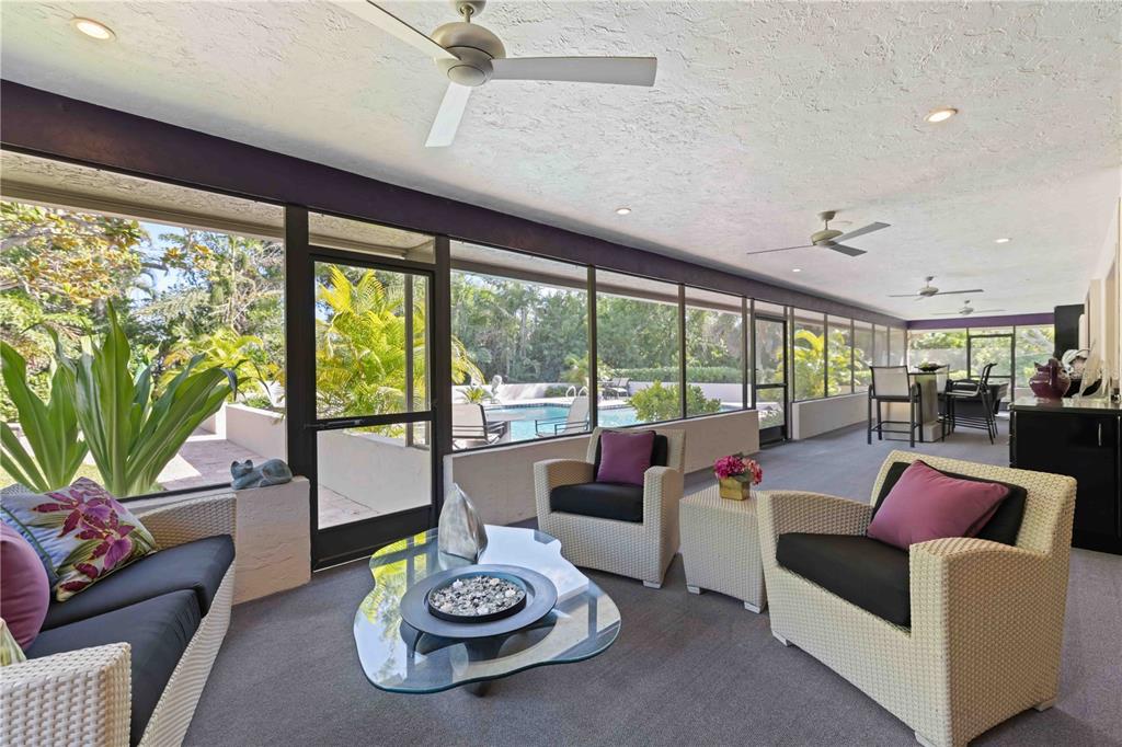 505 Lyons Bay Road Nokomis, FL 34275 - Photo 27 of 57 a living room with furniture and a floor to ceiling window