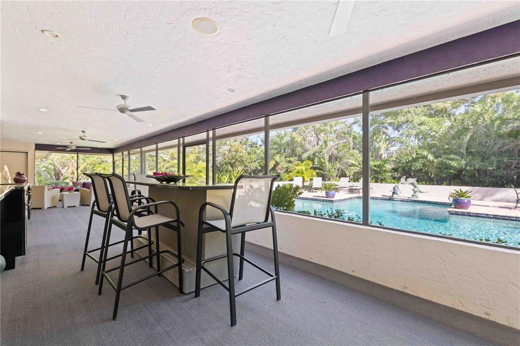 505 Lyons Bay Road Nokomis, FL 34275 - Photo 30 of 57 a dining room with furniture and a floor to ceiling window
