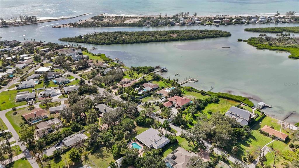505 Lyons Bay Road Nokomis, FL 34275 - Photo 54 of 57 an aerial view of lake residential house with outdoor space and trees around