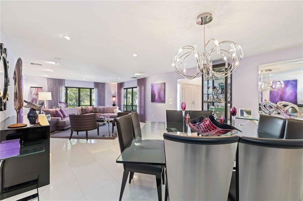 505 Lyons Bay Road Nokomis, FL 34275 - Photo 8 of 57 a view of a dining room with furniture and a chandelier