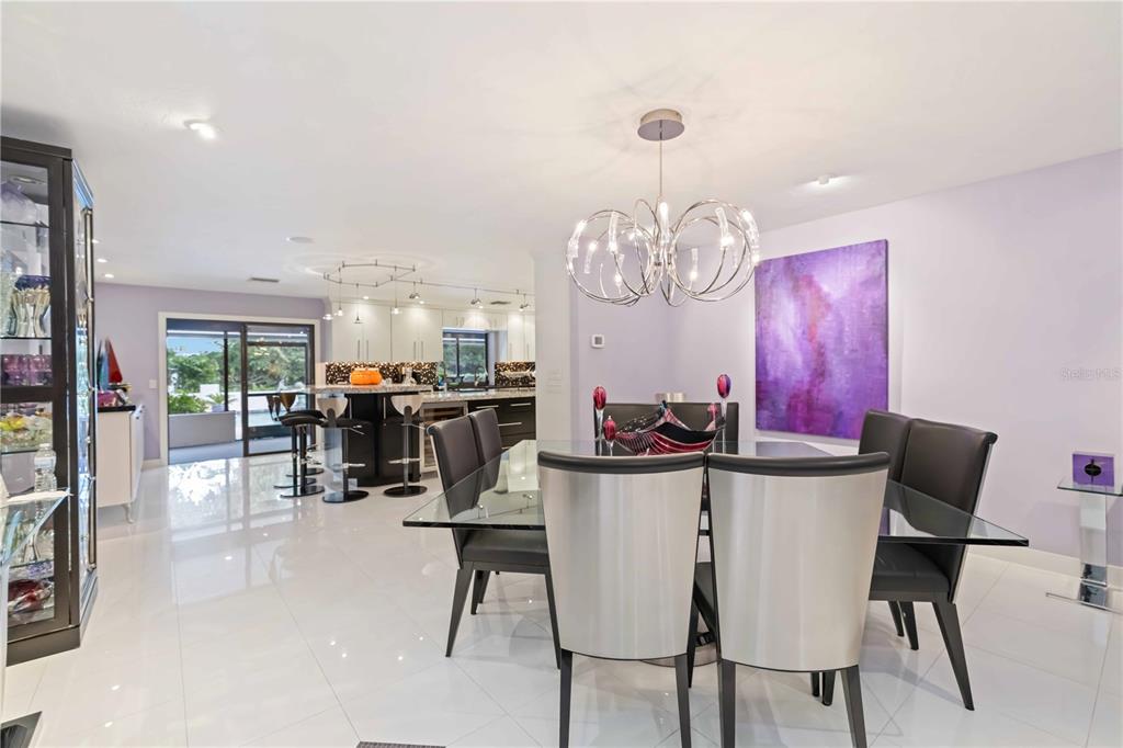 505 Lyons Bay Road Nokomis, FL 34275 - Photo 10 of 57 a view of a dining room with furniture and chandelier