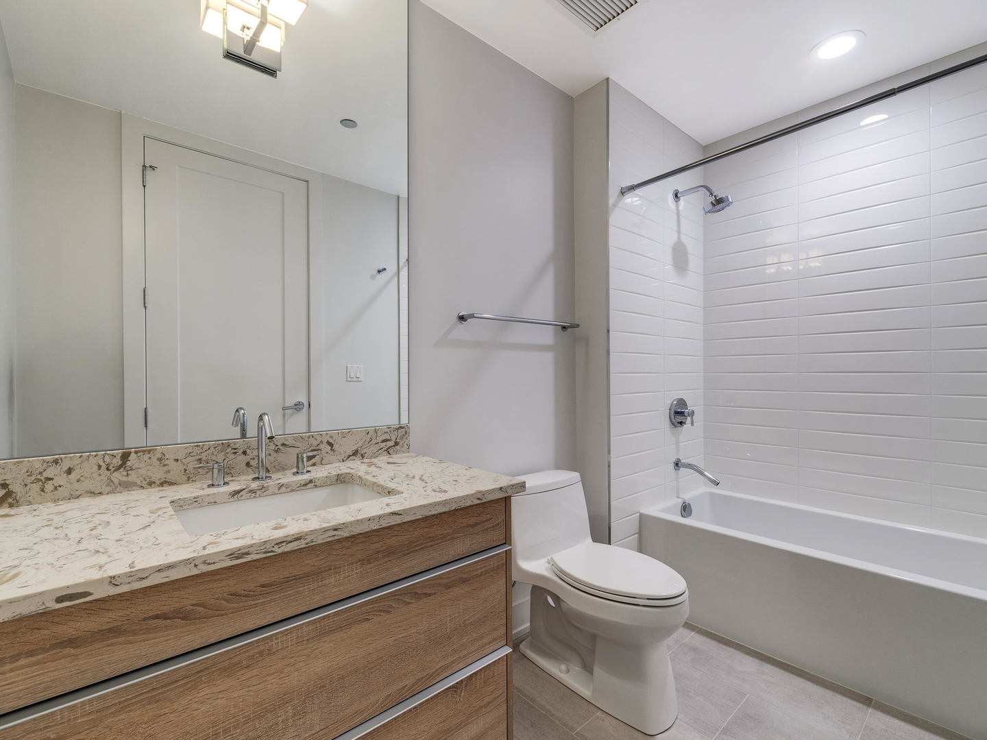 2 West Delaware Place, Unit 130304 Chicago, IL 60610 - Photo 14 of 19 a bathroom with a granite countertop toilet sink and shower