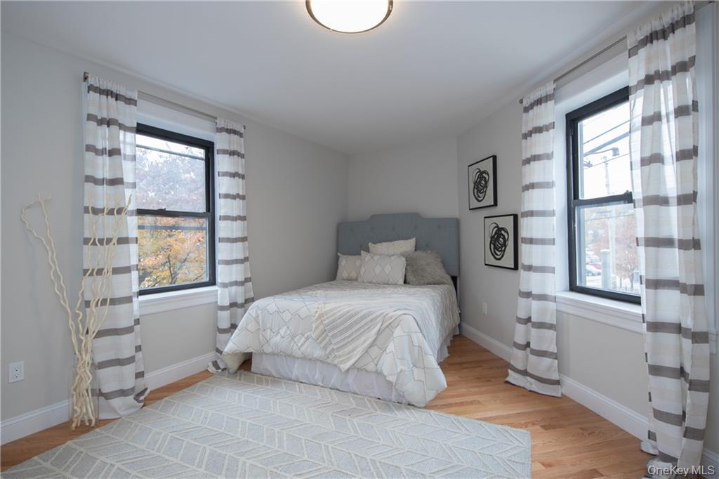 381 Broadway, Unit 1B Dobbs Ferry, NY 10522 - Photo 13 of 16 a bedroom with a bed and a window