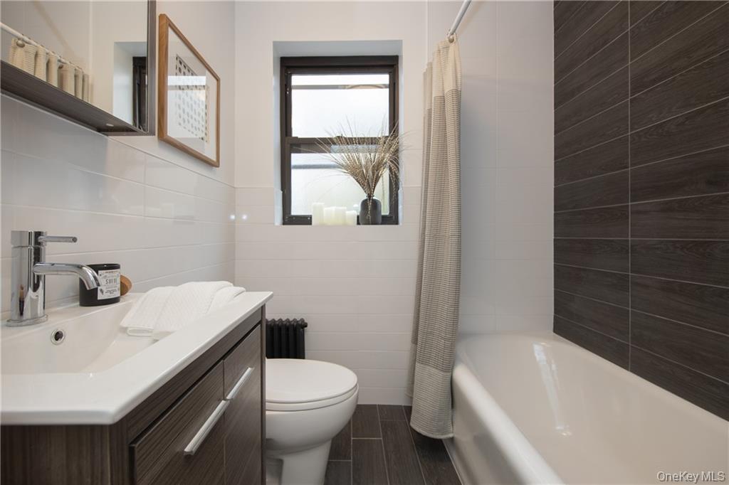 381 Broadway, Unit 1B Dobbs Ferry, NY 10522 - Photo 14 of 16 a bathroom with a sink toilet and bathtub