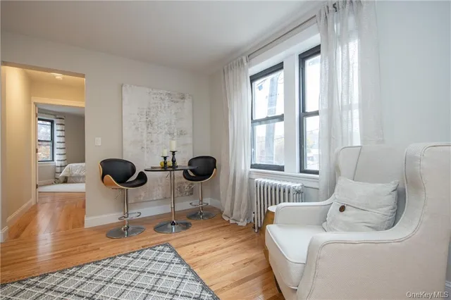 a living room with furniture a window and chairs