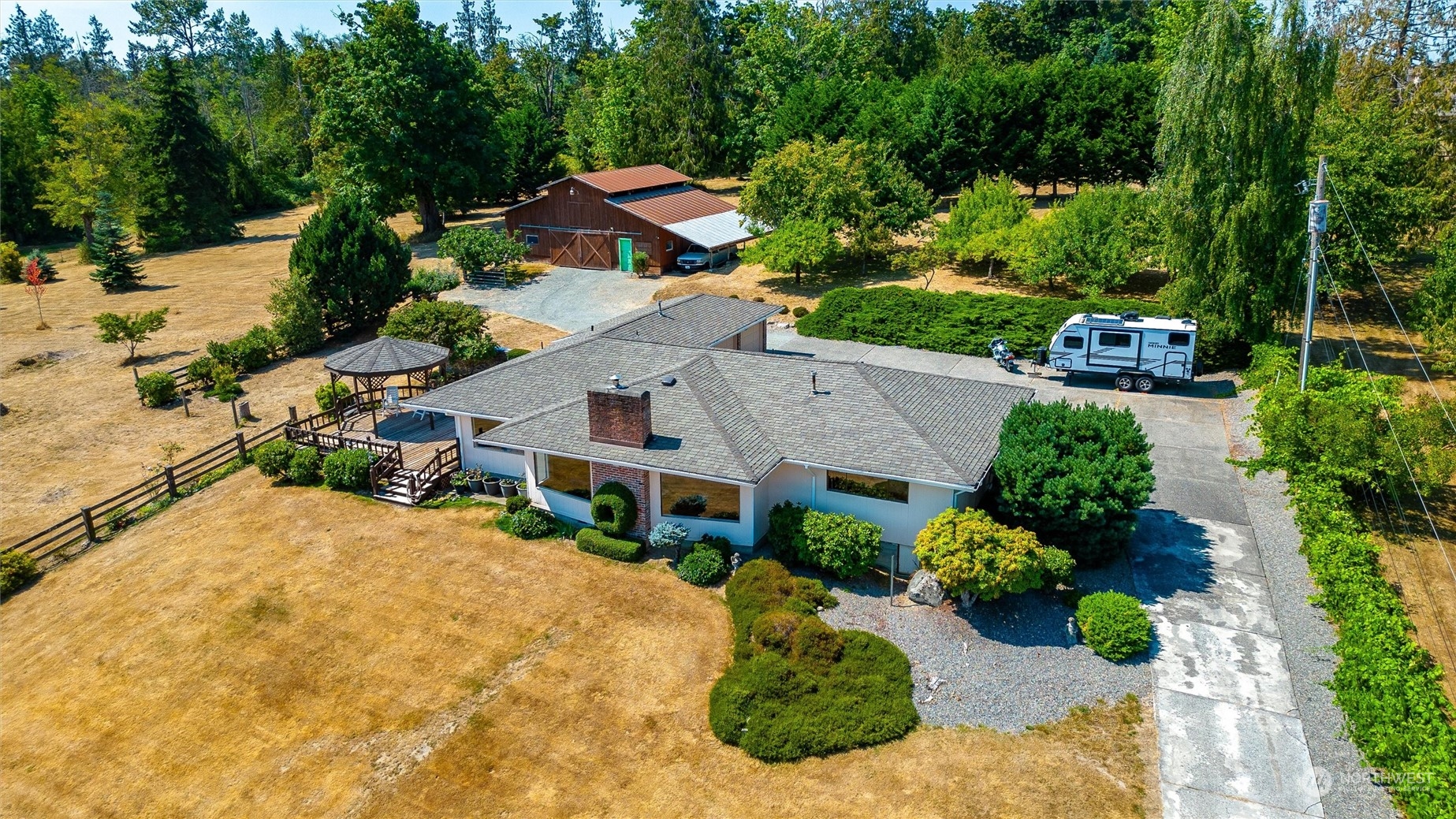 an aerial view of a house with yard and green space