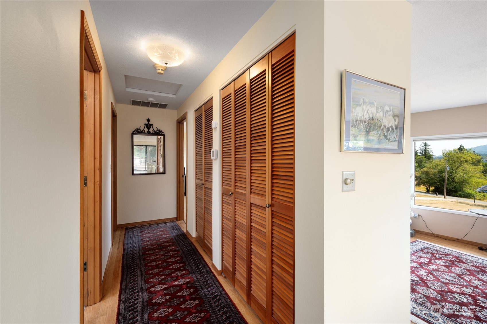 13622 Trumpeter Lane Mount Vernon, WA 98273 - Photo 23 of 40 a view of a hallway with wooden floor and a dining room