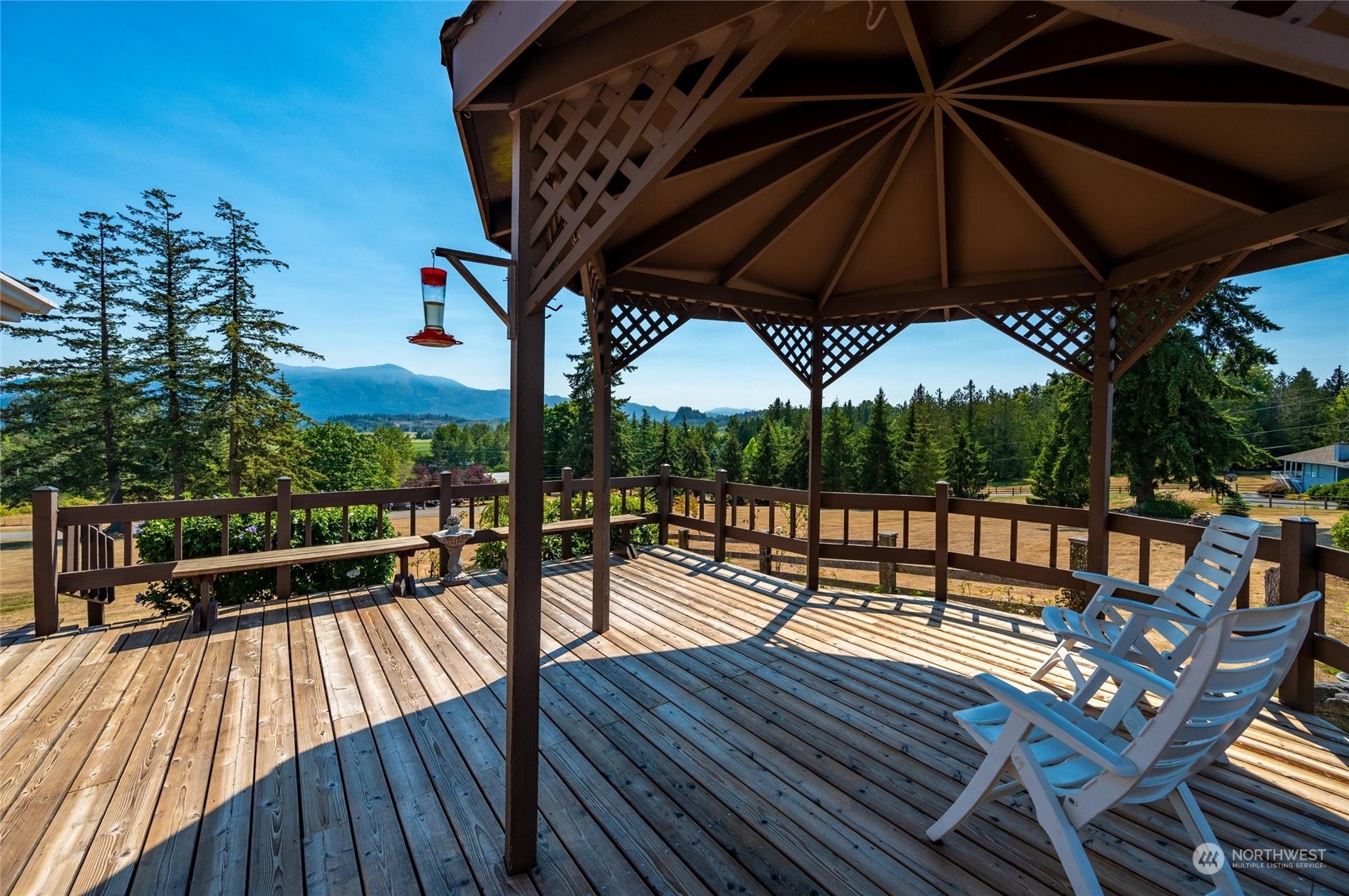 13622 Trumpeter Lane Mount Vernon, WA 98273 - Photo 36 of 40 a view of a roof deck with table and chairs under an umbrella