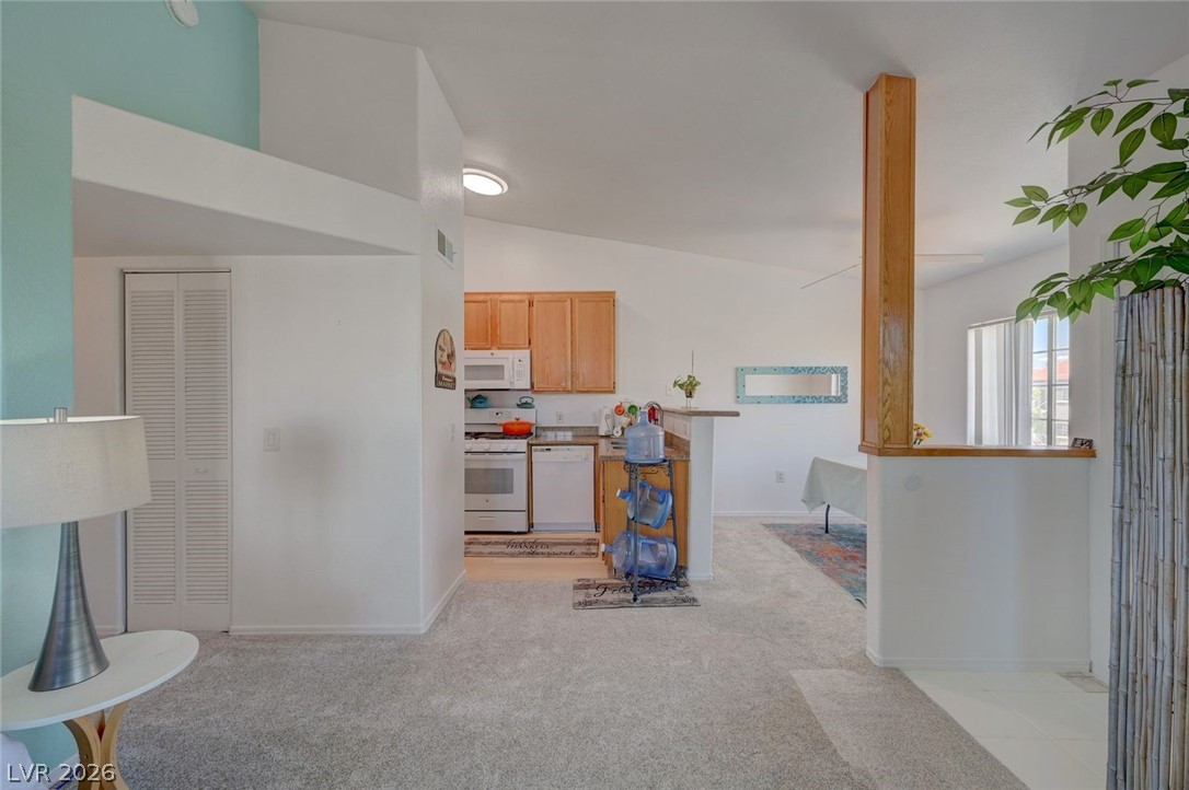 3318 North Decatur Boulevard, Unit 2072 Las Vegas, NV 89130 - Photo 49 of 50 An inviting open floorplan with vaulted ceilings connects the living space to a functional kitchen.