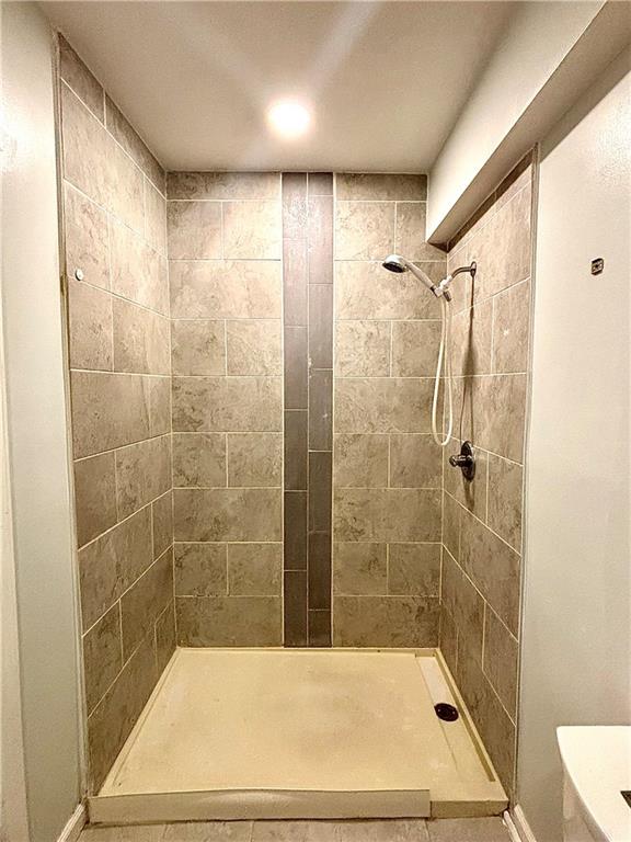 4030 Stonewall Tell Road Atlanta, GA 30349 - Photo 11 of 23 a bathroom with a bathtub and a shower