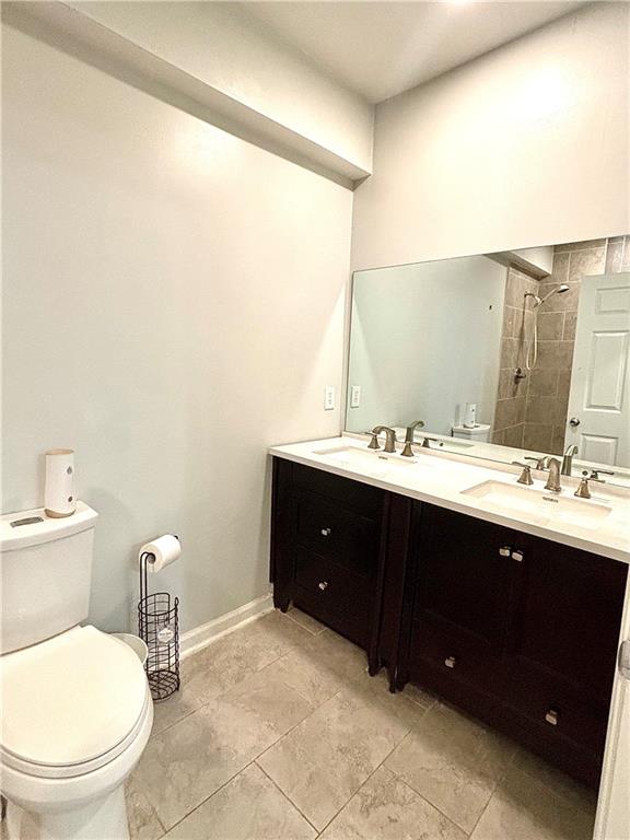 4030 Stonewall Tell Road Atlanta, GA 30349 - Photo 12 of 23 a bathroom with a sink and a toilet